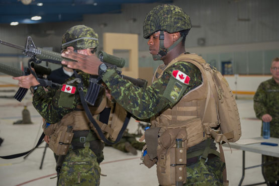 Two soldiers carrying guns side by side
